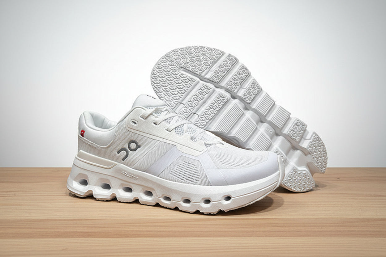 White athletic shoes on a gray surface with a black background