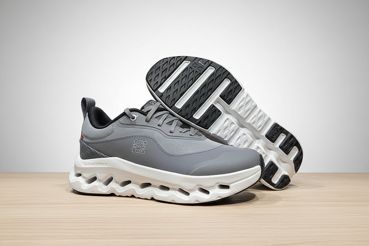 Gray and white sneakers on a light gray surface with a black background