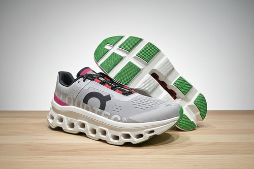 Gray and green running shoe on a wooden surface with a gray background