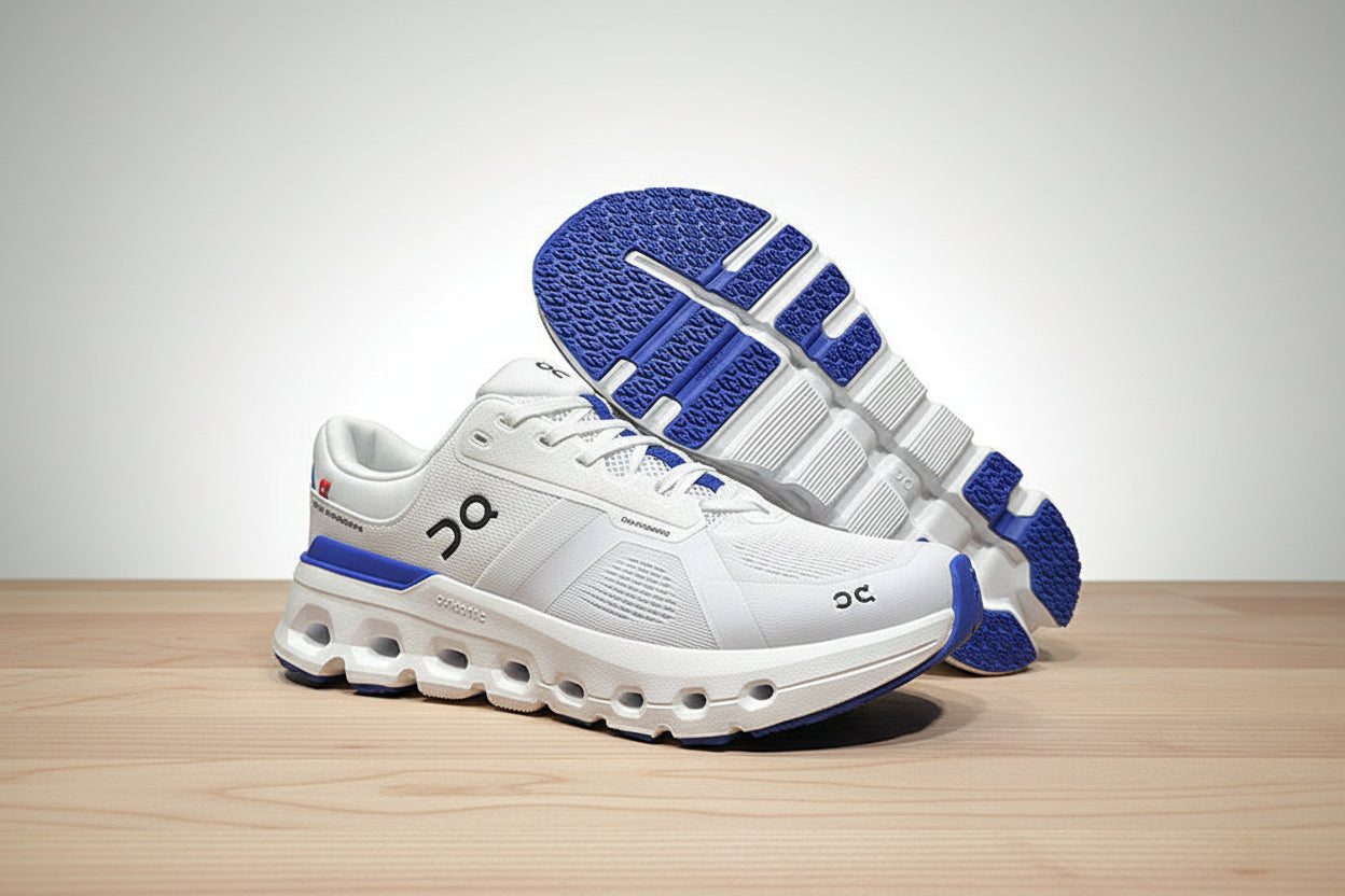 White and blue athletic shoes on a gray surface with a black background