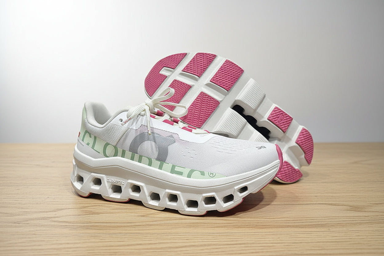 White and pink sneakers on a gray surface with a black background