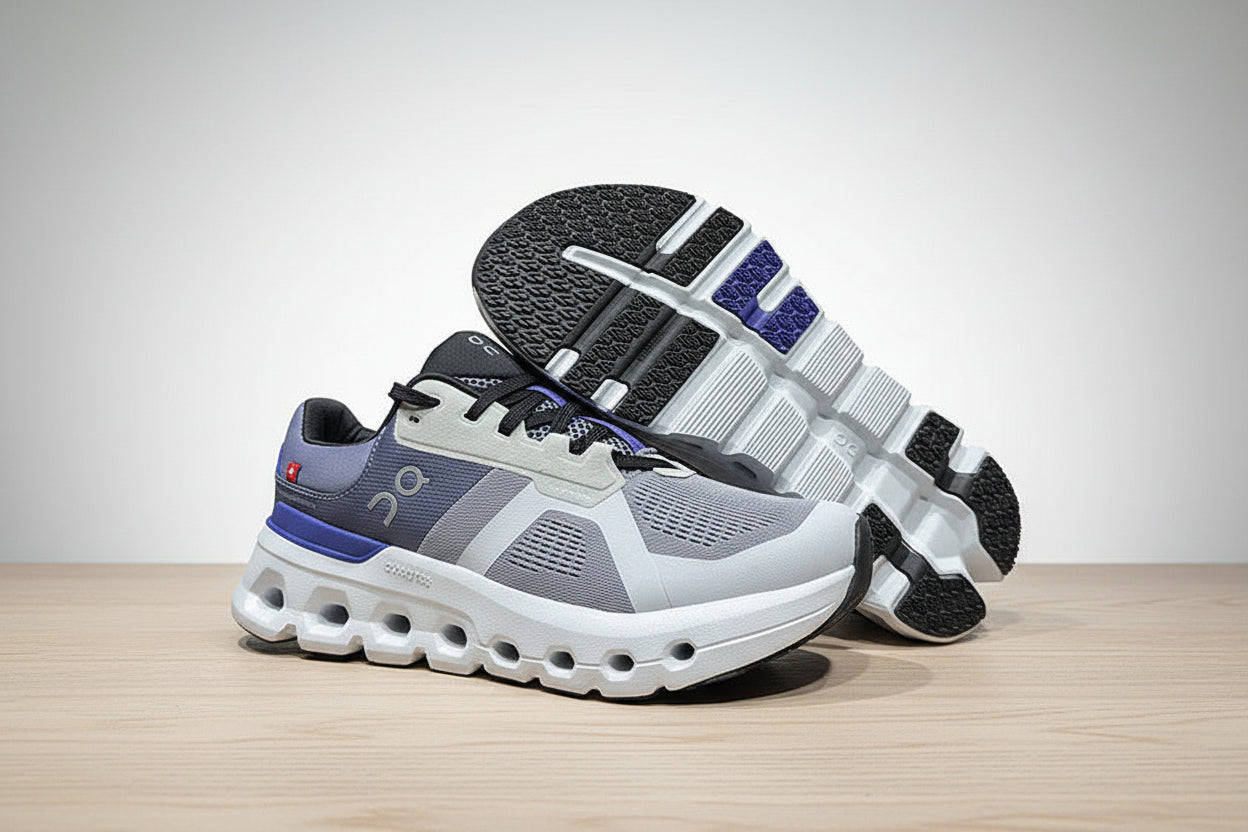 Gray and blue athletic shoes on a light gray surface with a black background