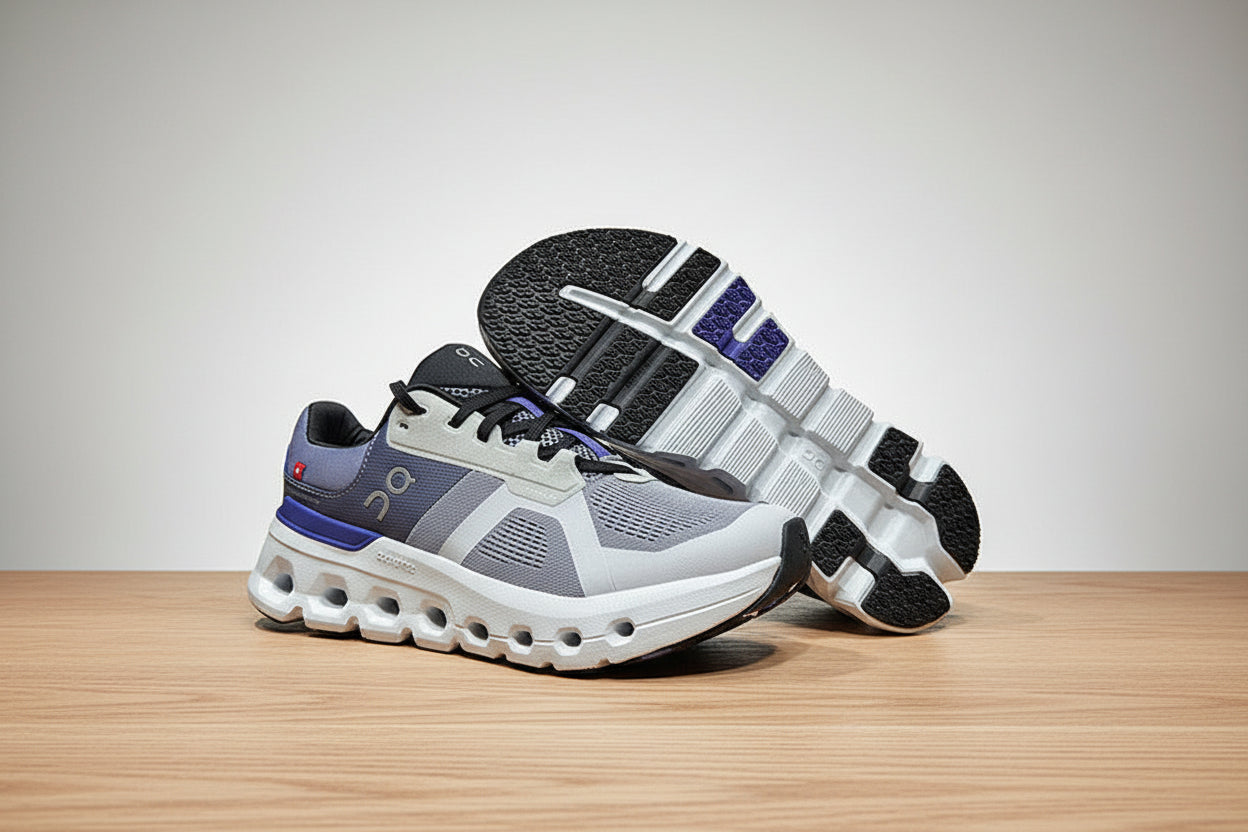 Gray and blue athletic shoes on a light gray surface with a black background