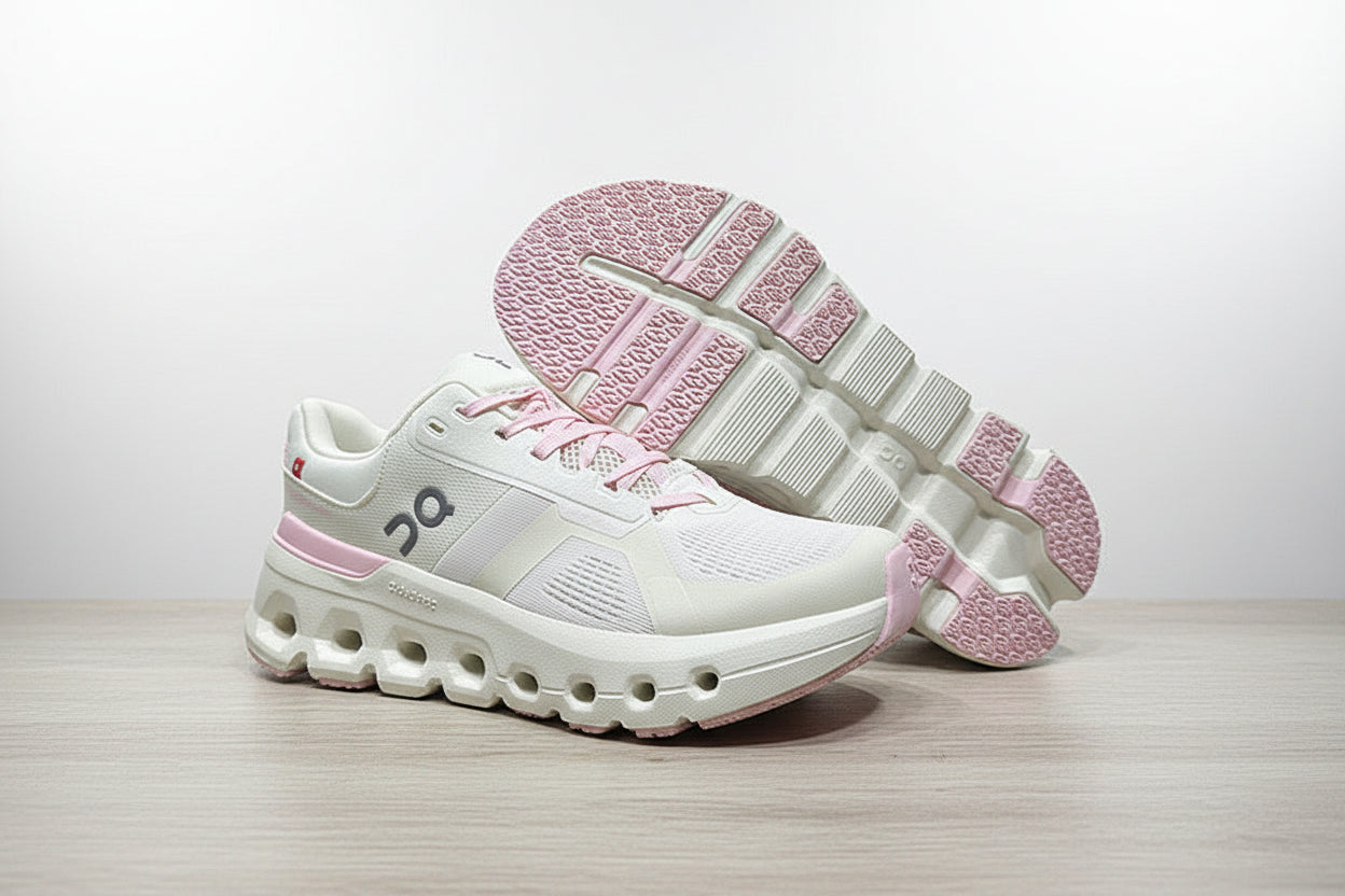 White and pink sneakers on a light gray surface with a black background