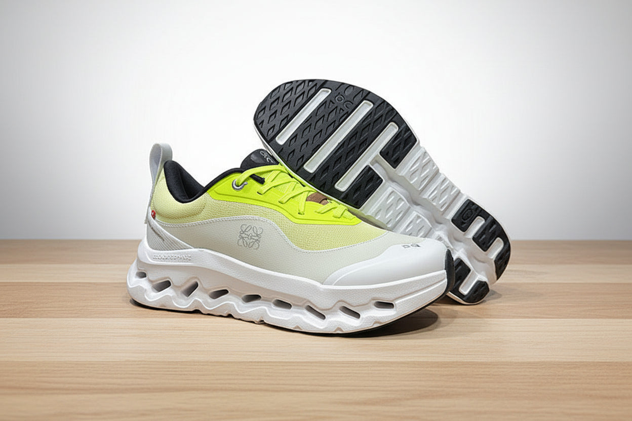 Pair of neon green and white sneakers on a gray surface with a black background