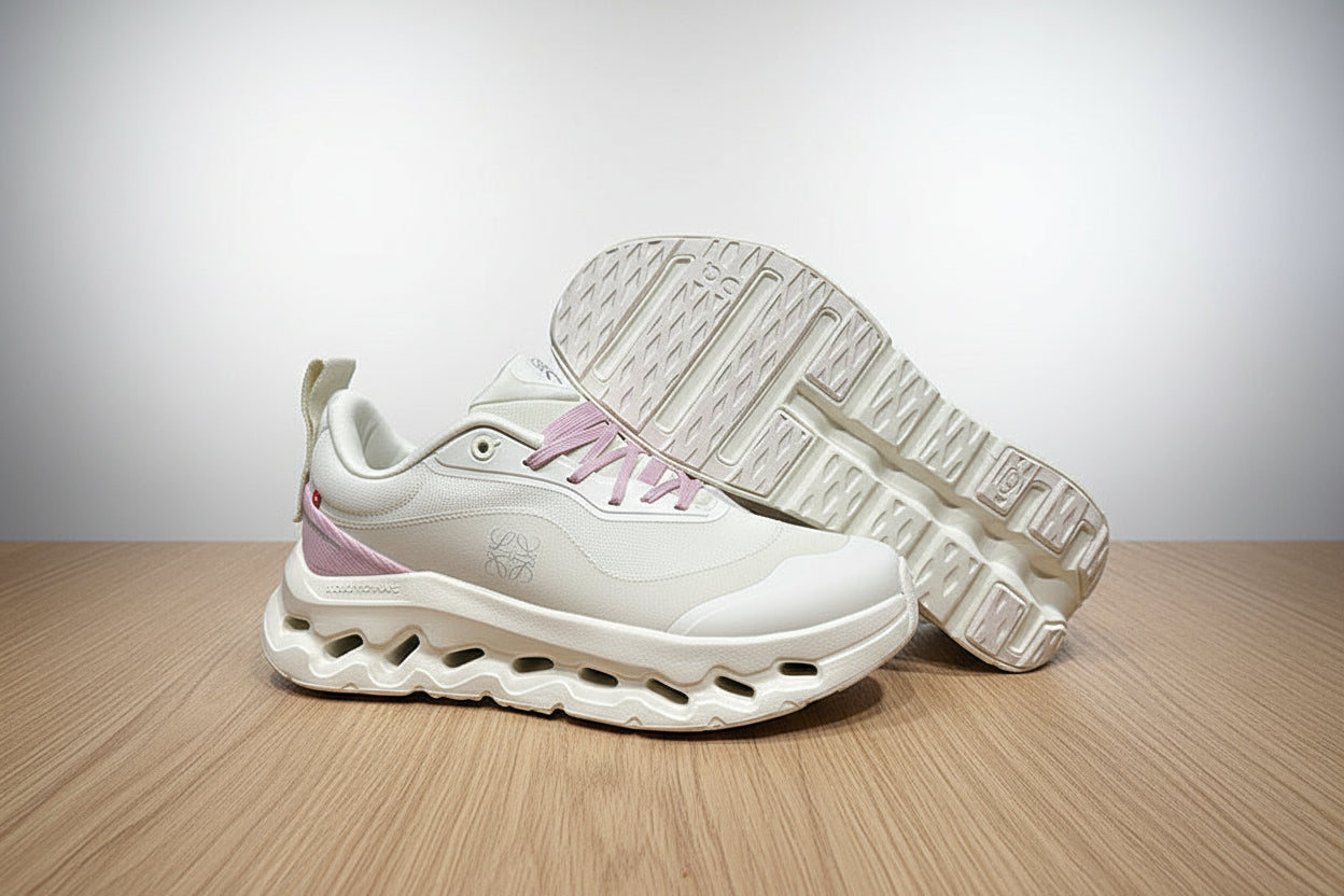White sneakers with pink accents on a gray surface
