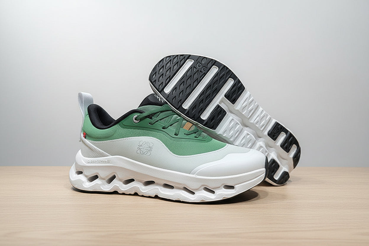 Green and white athletic shoes on a gray surface with a black background