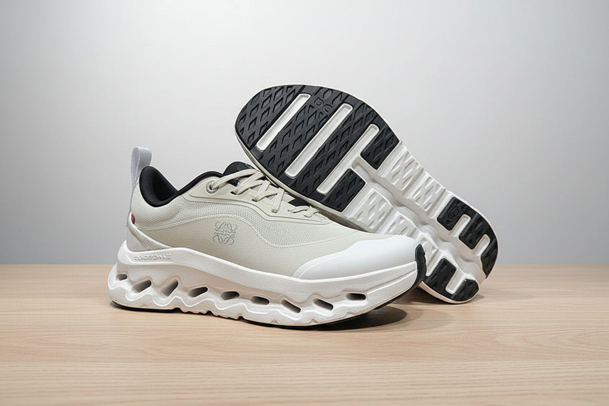 White and black athletic shoes on a gray surface with a black background