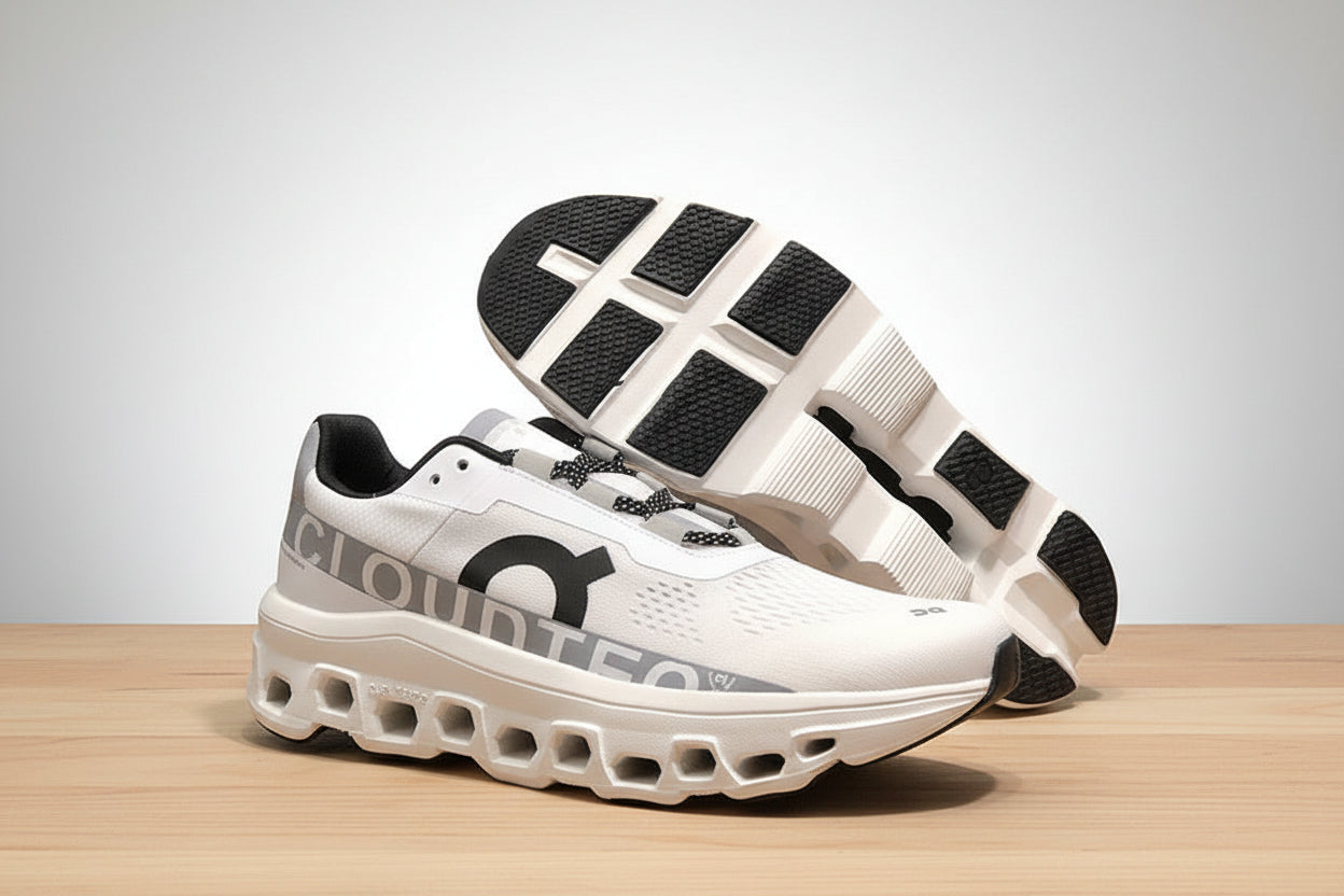 White athletic shoes with black accents on a white surface against a black background