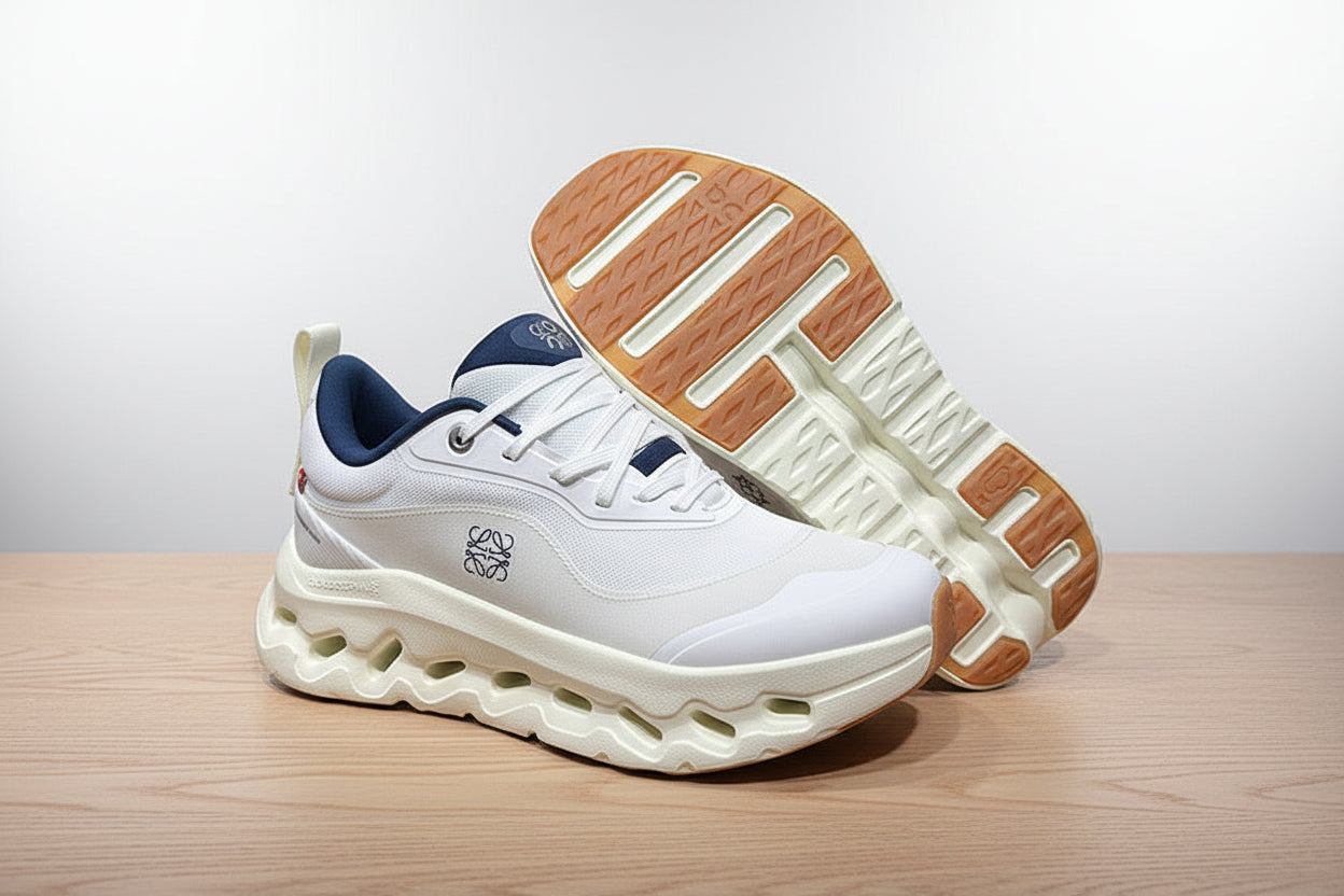 White sneakers with brown soles on a gray surface