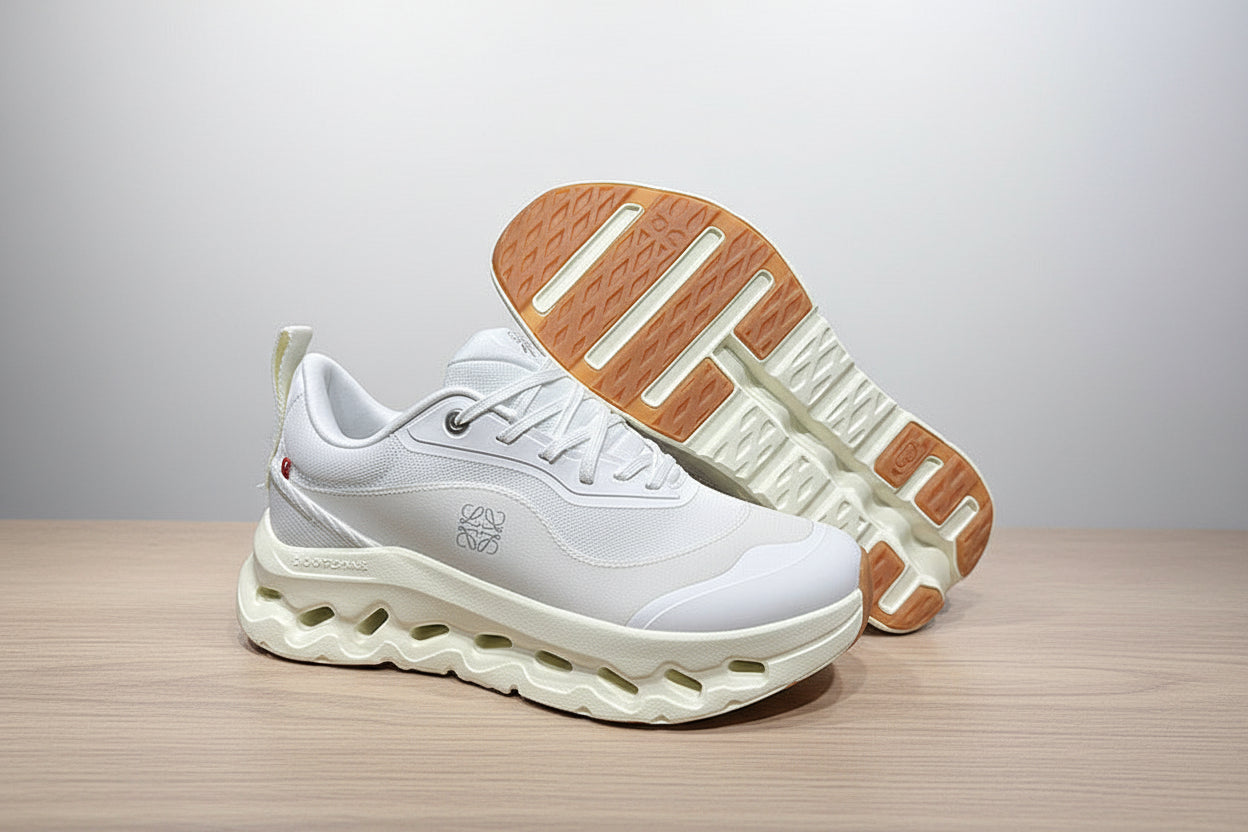 White sneakers with brown soles on a gray surface